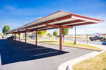 A parking lot with a red and white canopy.